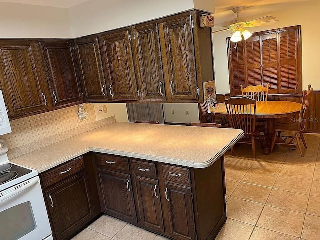 kitchen with ceiling fan, dark brown cabinets, light tile patterned flooring, and white electric range