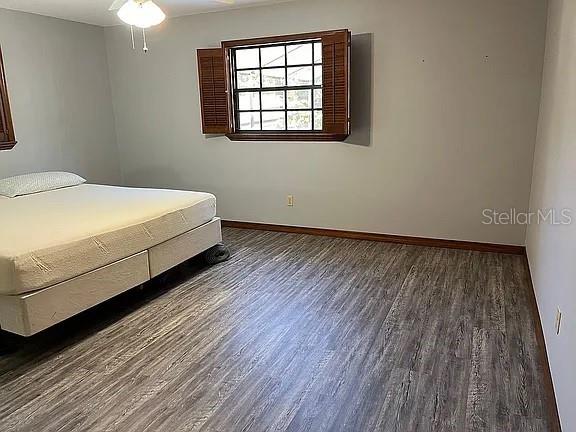 unfurnished bedroom with dark wood-type flooring