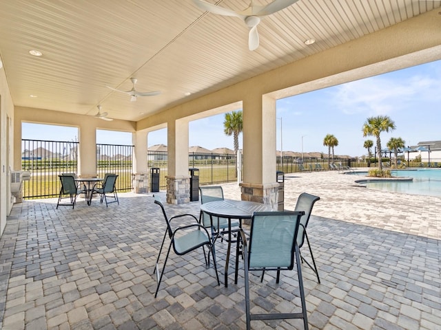 view of patio featuring ceiling fan and a community pool