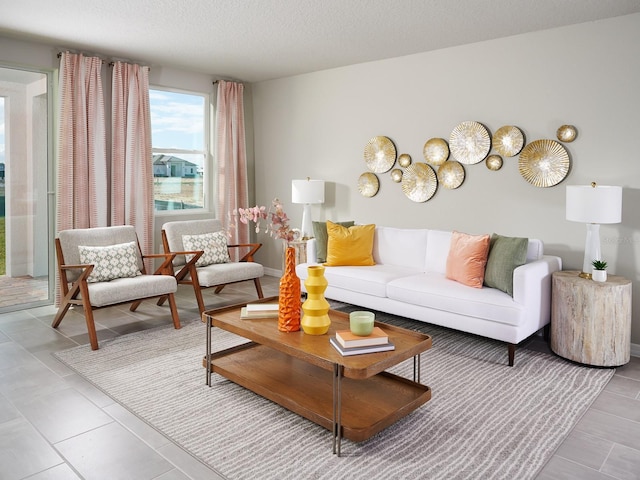 tiled living room featuring a textured ceiling