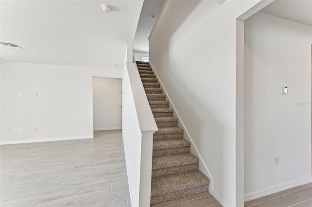 stairs with hardwood / wood-style floors