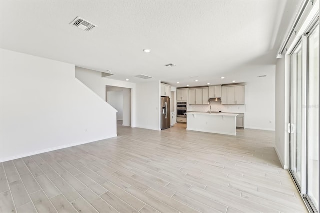 unfurnished living room with light wood-type flooring