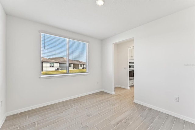 empty room with light hardwood / wood-style floors