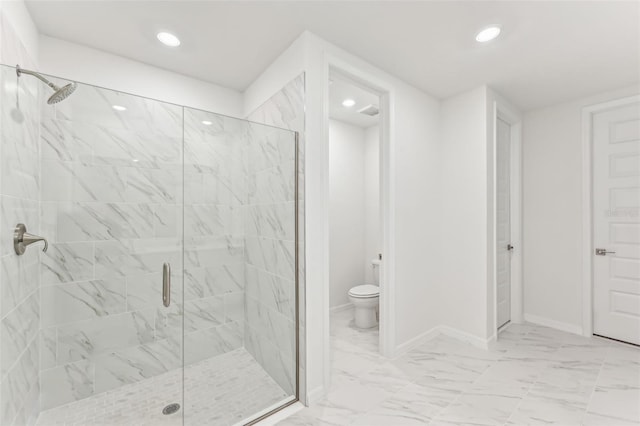 bathroom with an enclosed shower and toilet