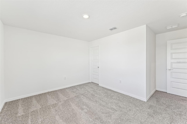 unfurnished room featuring light colored carpet