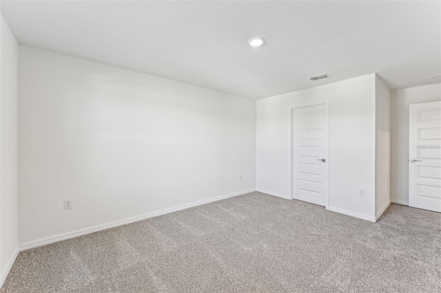 unfurnished bedroom featuring carpet flooring and a closet