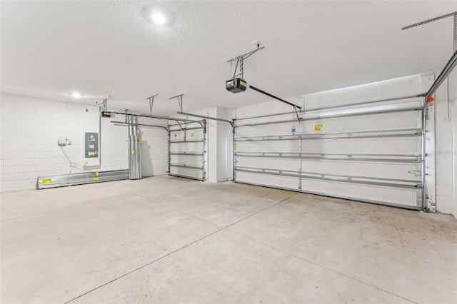 garage featuring a garage door opener and electric panel