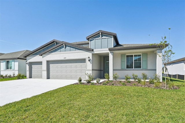 view of front of property featuring concrete driveway, an attached garage, a front lawn, and stucco siding