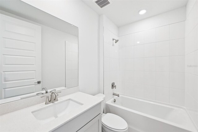 full bath with visible vents, vanity, toilet, and bathing tub / shower combination