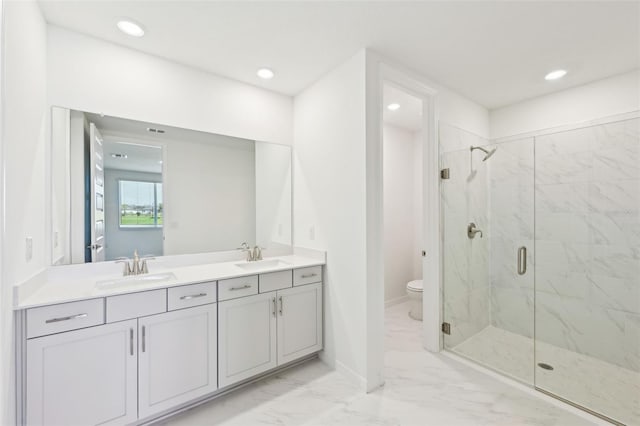 full bath with toilet, marble finish floor, a marble finish shower, and a sink