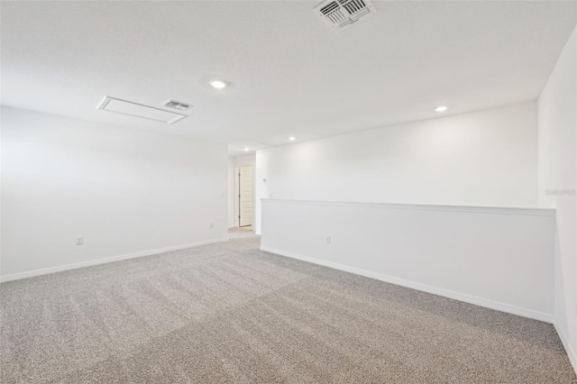 carpeted empty room with visible vents, recessed lighting, and baseboards