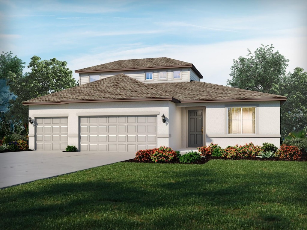 view of front of home featuring a front yard and a garage