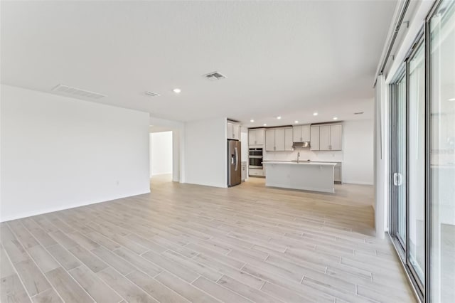 unfurnished living room featuring light wood-type flooring