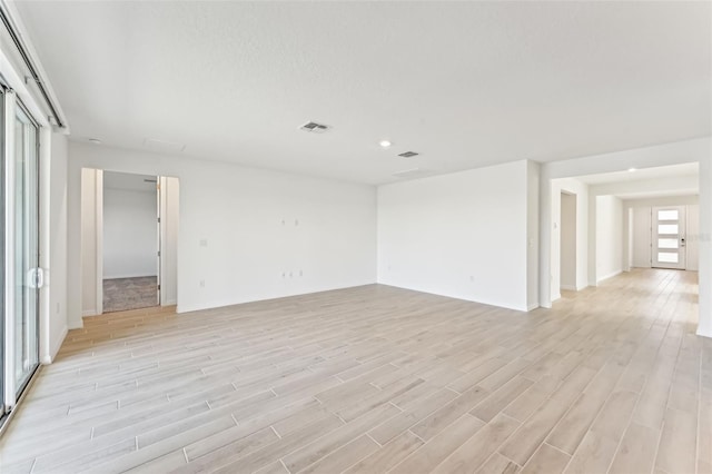 spare room with light wood-type flooring