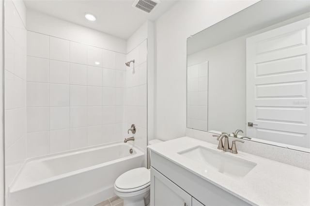 full bathroom with toilet, tiled shower / bath, tile patterned floors, and vanity