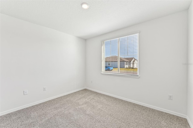 unfurnished room featuring carpet flooring