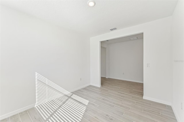 unfurnished room featuring light hardwood / wood-style floors