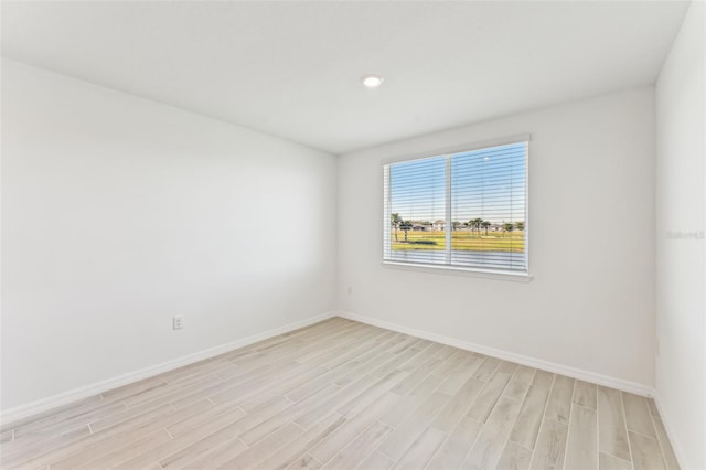 unfurnished room with light hardwood / wood-style floors