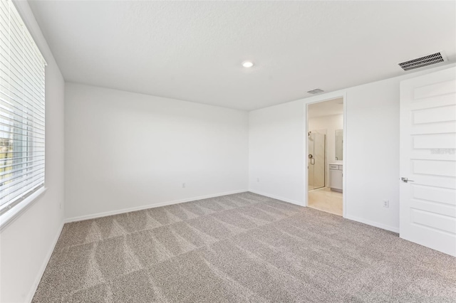 spare room with light carpet