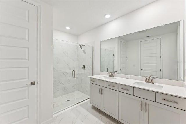 bathroom featuring vanity and a shower with shower door