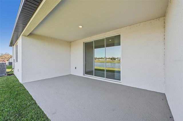 view of patio / terrace with central AC and a water view