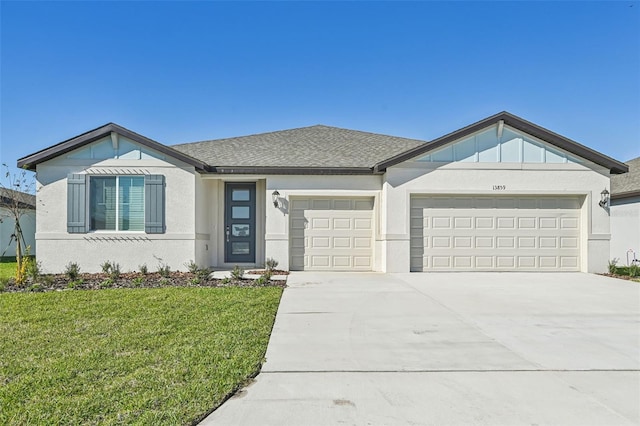 view of front facade with a garage and a front lawn