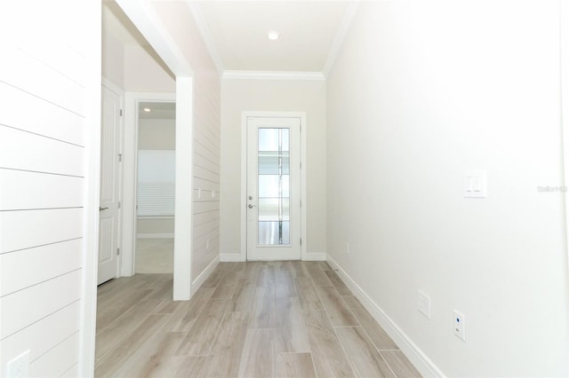 corridor featuring light wood-type flooring and crown molding