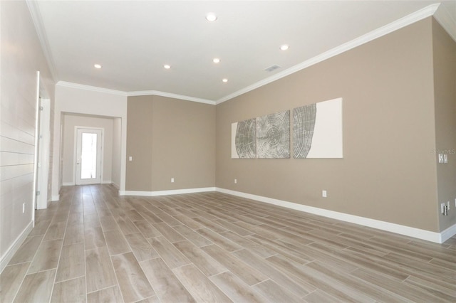 spare room with light hardwood / wood-style floors and ornamental molding