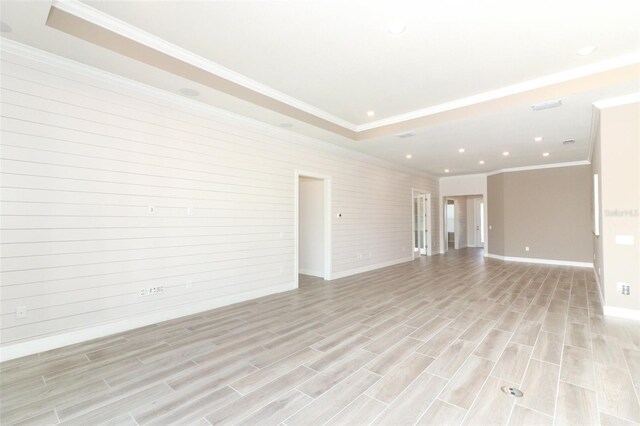 unfurnished living room featuring light hardwood / wood-style floors and crown molding