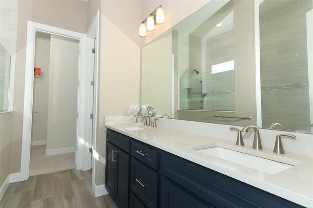 bathroom with vanity and a tile shower