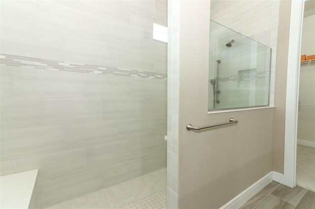 bathroom with a tile shower