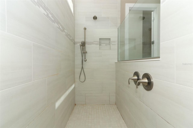 bathroom with a tile shower