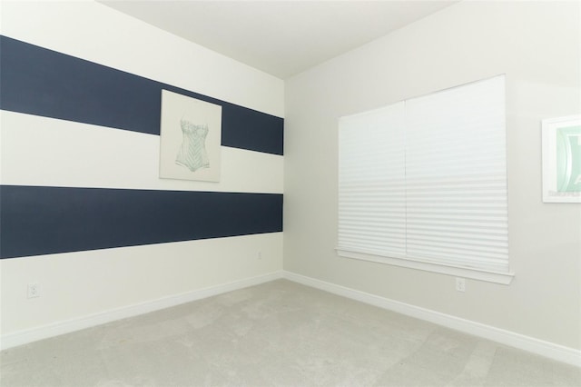 unfurnished room featuring light colored carpet