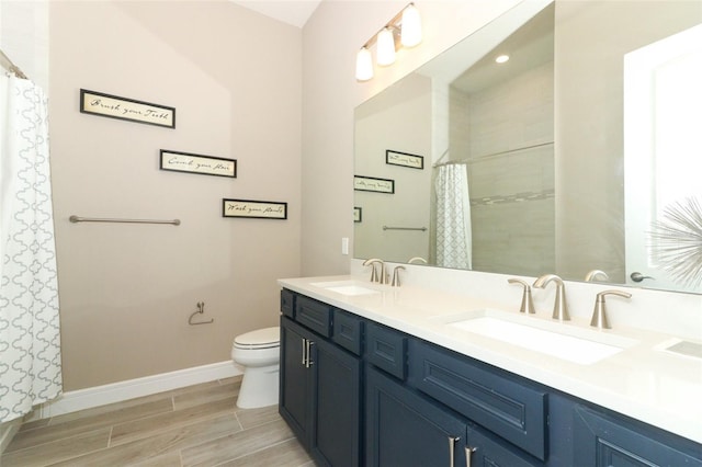 bathroom with a shower with shower curtain, vanity, and toilet