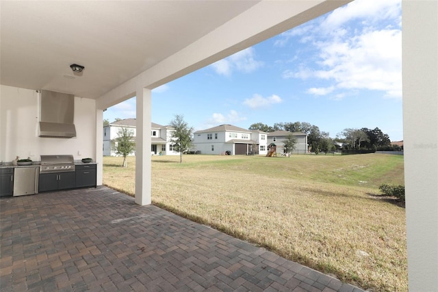 view of patio featuring an outdoor kitchen and area for grilling