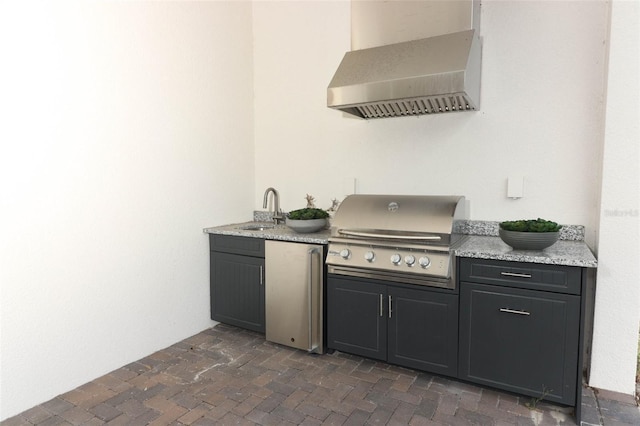 view of patio / terrace featuring exterior kitchen, sink, and grilling area