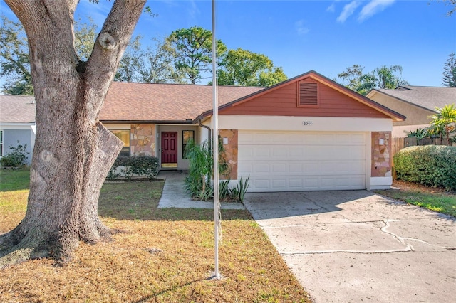 single story home with a front yard and a garage