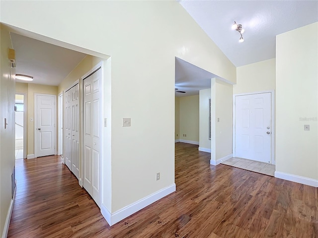 hall featuring hardwood / wood-style floors and lofted ceiling