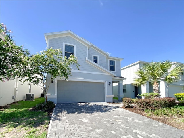 8956 Zurich Ln, Kissimmee, FL 34747 - traditional home with an attached garage, decorative driveway, and stucco siding