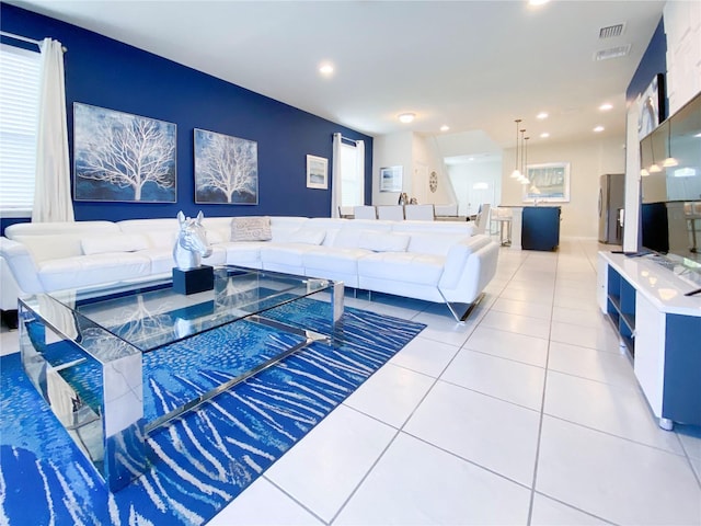 tiled living room featuring a healthy amount of sunlight