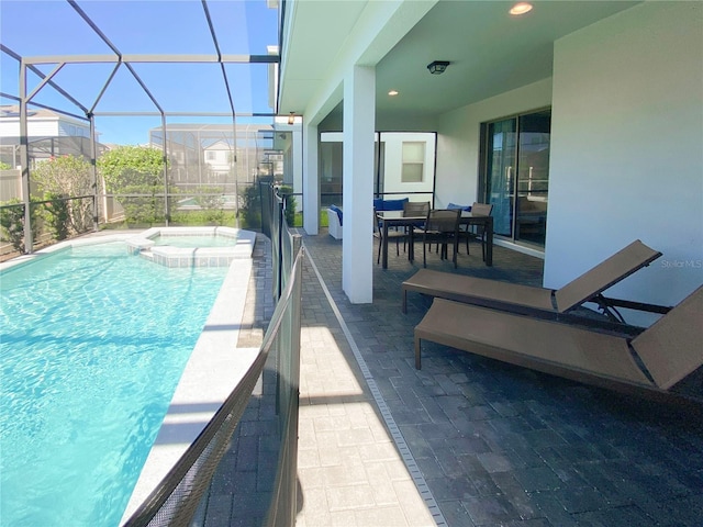 8956 Zurich Ln, Kissimmee, FL 34747 - view of pool featuring a pool with connected hot tub, a patio area, and glass enclosure