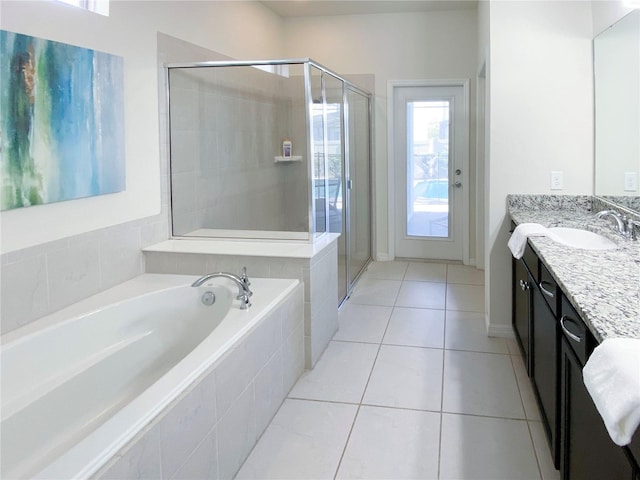 bathroom with tile patterned flooring, vanity, and independent shower and bath