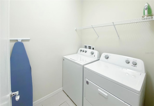 8956 Zurich Ln, Kissimmee, FL 34747 - laundry area with washing machine and clothes dryer and light tile patterned flooring