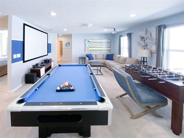 game room featuring a textured ceiling, light colored carpet, and billiards