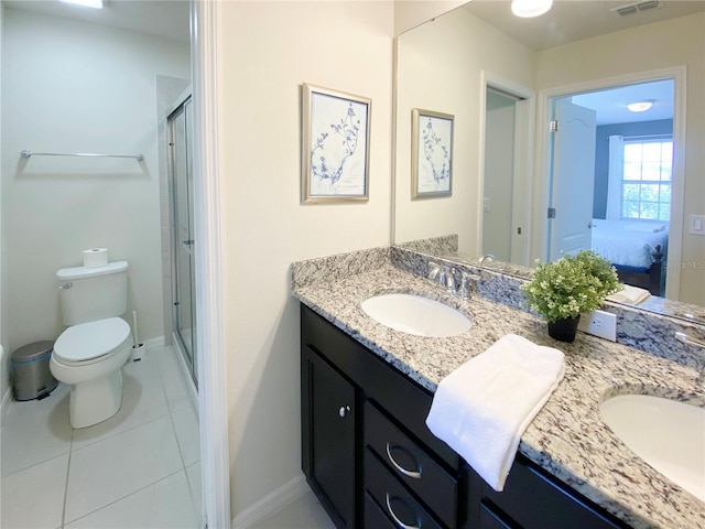 bathroom with tile patterned floors, vanity, toilet, and a shower with shower door