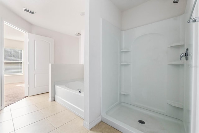 bathroom featuring tile patterned flooring and plus walk in shower