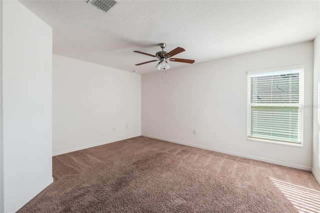 empty room with carpet floors, ceiling fan, and a textured ceiling