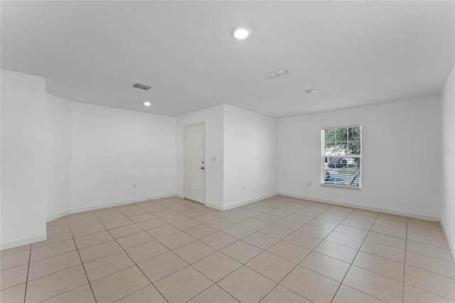 spare room featuring light tile patterned flooring