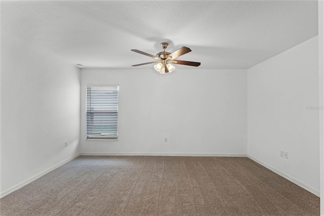 carpeted spare room with a textured ceiling and ceiling fan