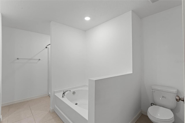 bathroom with toilet, tile patterned flooring, and a bathing tub